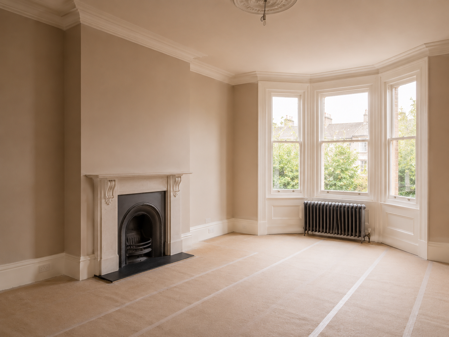 Elegant period room in Bath finished by DSB Plastering, with original fireplace and bay window